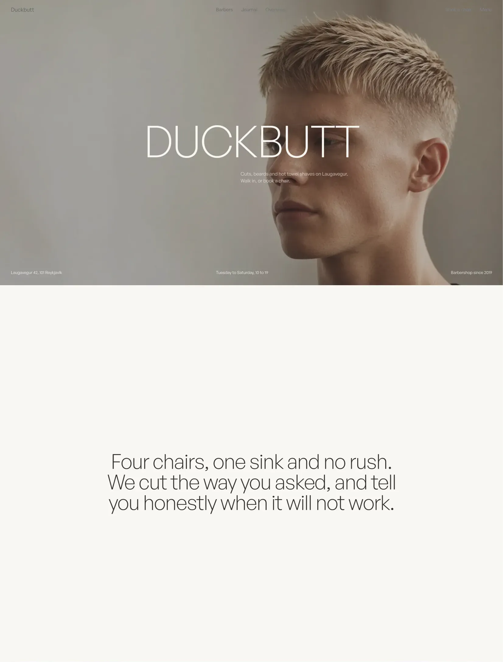 Duckbutt barbershop homepage with the name over a full bleed portrait and a one line statement about the shop