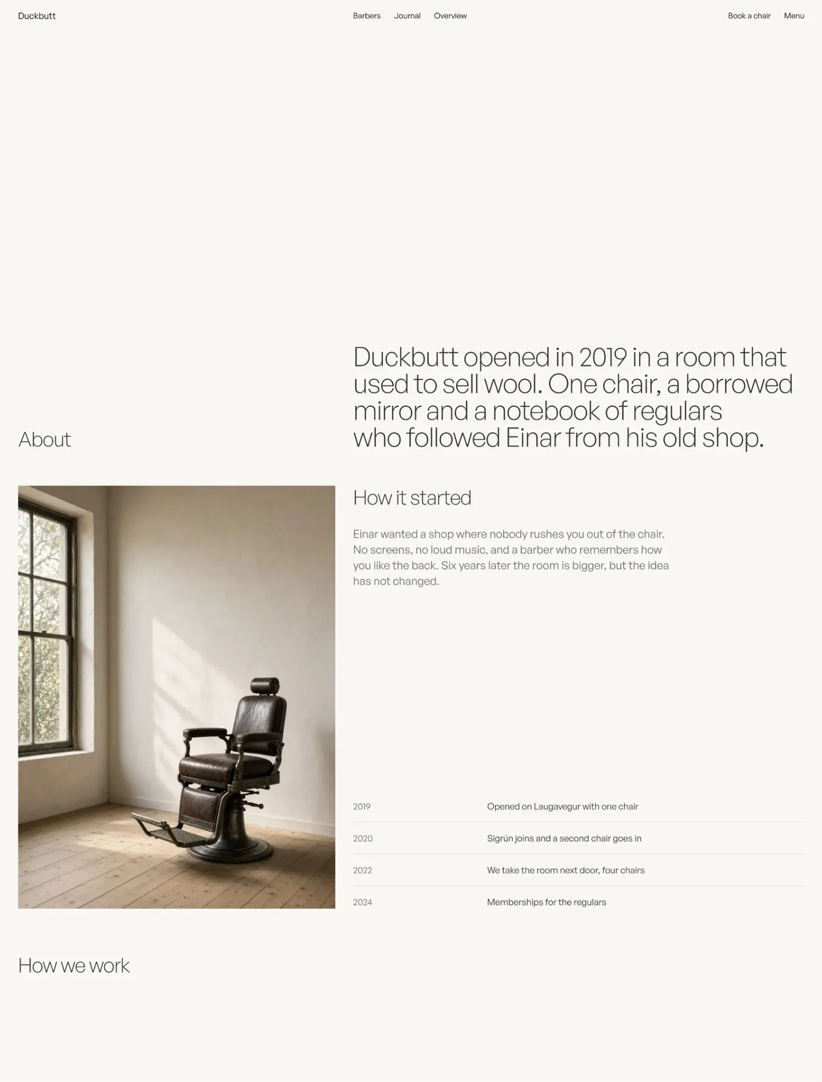 Duckbutt about page with an empty barber chair by the window and the shop's timeline